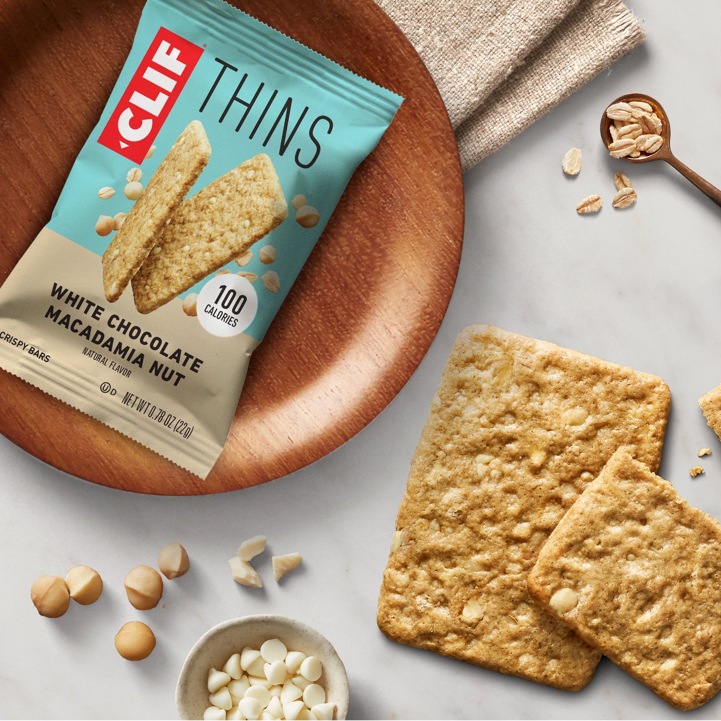 CLIF BAR Thins - White Chocolate Macadamia Nut Flavor - Crispy Snack Bars - Made with Organic Oats - Non-GMO - Plant-Based - 100 Calorie Packs - 0.78 oz. (7 Pack)